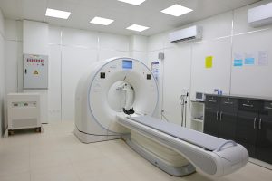 Bright and sterile hospital imaging room featuring a state-of-the-art CT scanner.
