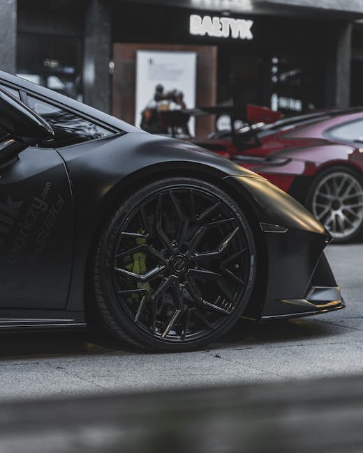 Luxury sports cars parked on an urban street in Poznań, showcasing sleek design and modern architecture in the background.